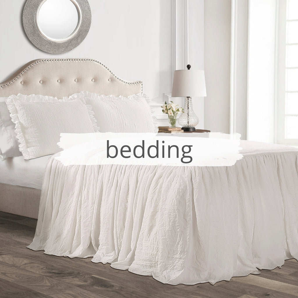 White waterfall ruffle bedspread on bed in farmhouse styled room
