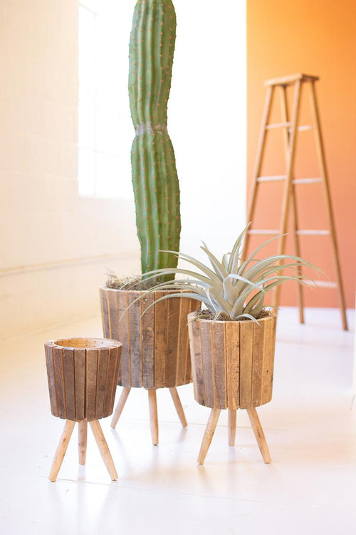 SET OF THREE ROUND RECYCLED WOODEN PLANTERS WITH LEGS