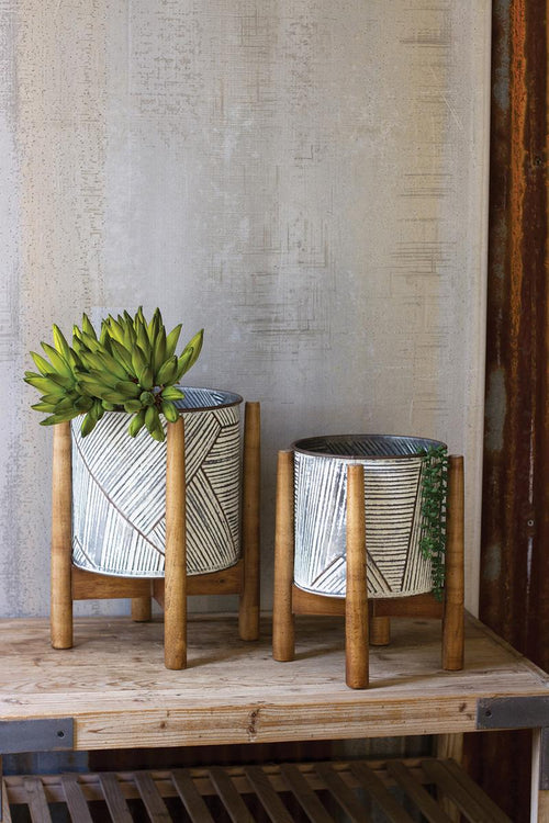 SET OF TWO PRESSED TIN PLANTERS WITH WOODEN BASES
