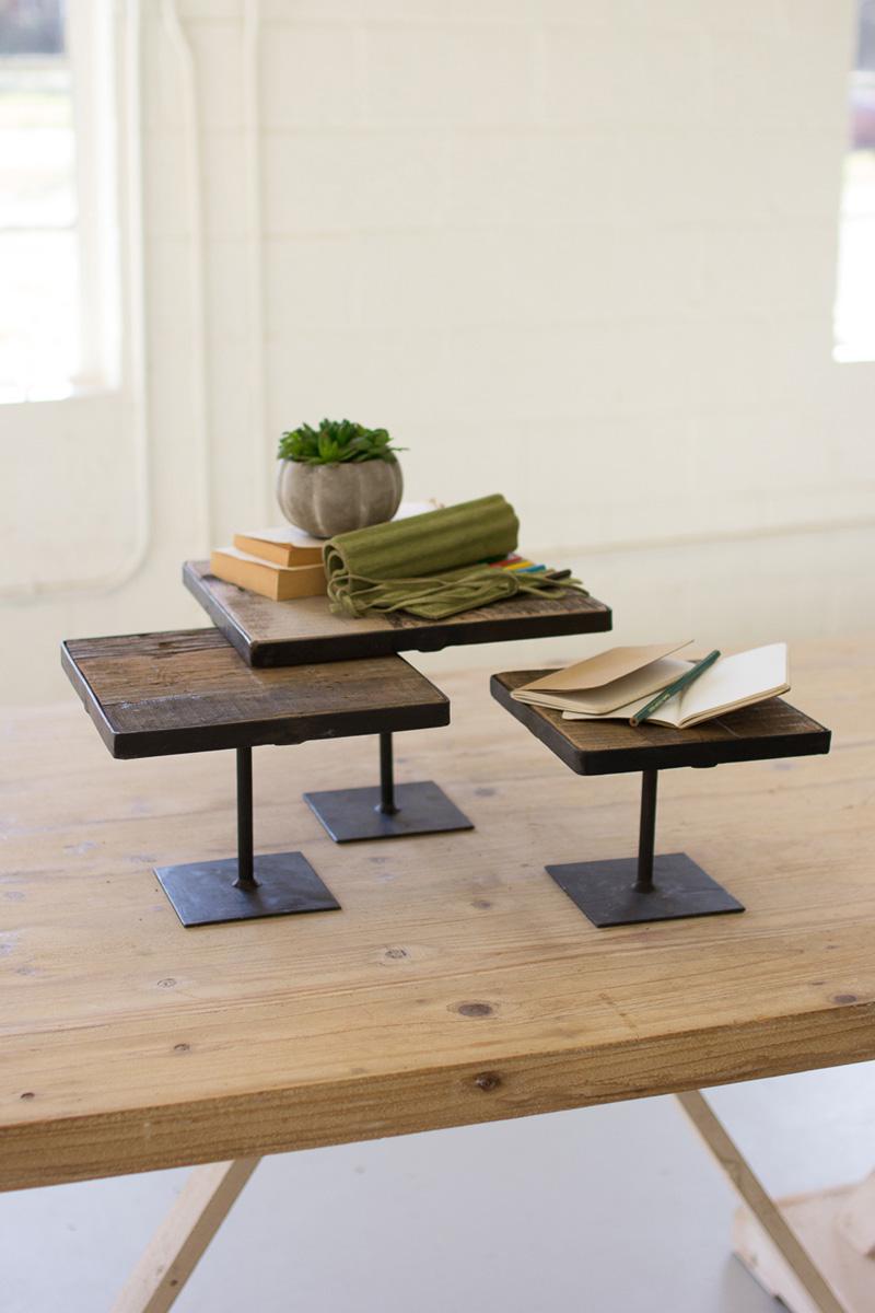 SET OF THREE RECYCLED WOOD RISERS W ANT BLACK METAL BASES